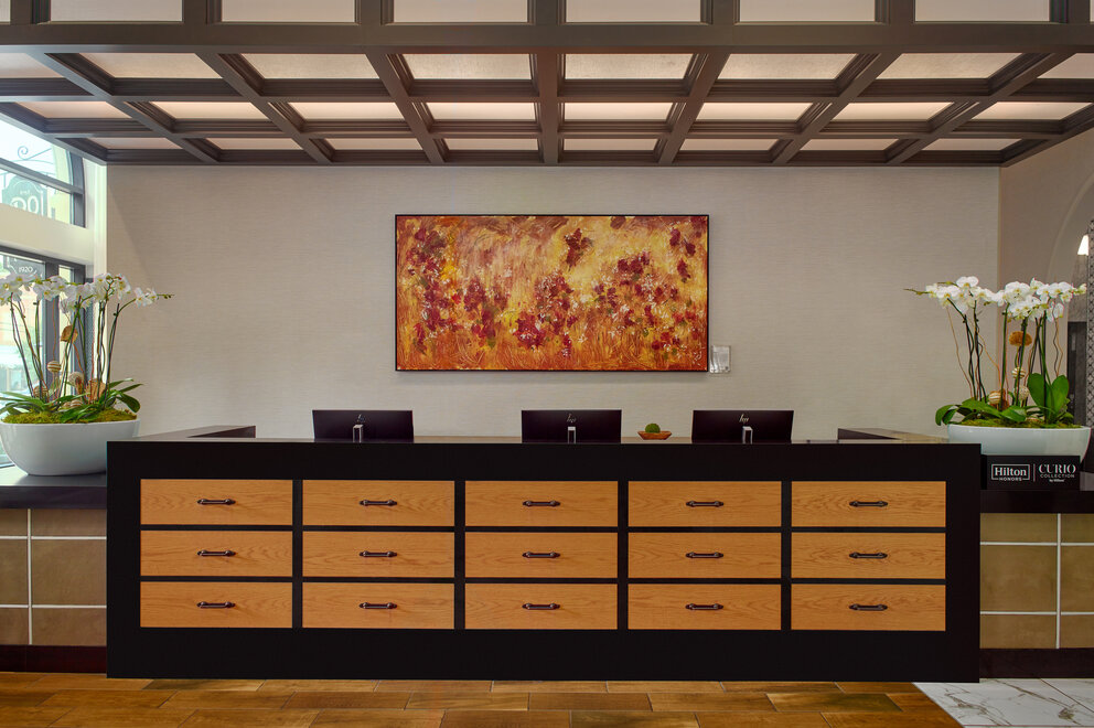 a large painting on the wall of a reception desk